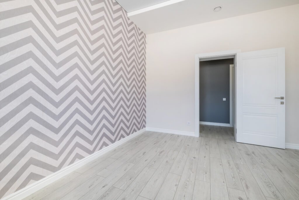 Find Professional Wallpaper Removal Near Me In Massachusetts 5 Chevron-pattern wallpaper installation in a modern home featuring light gray wallpaper, smooth white walls, and light wood flooring